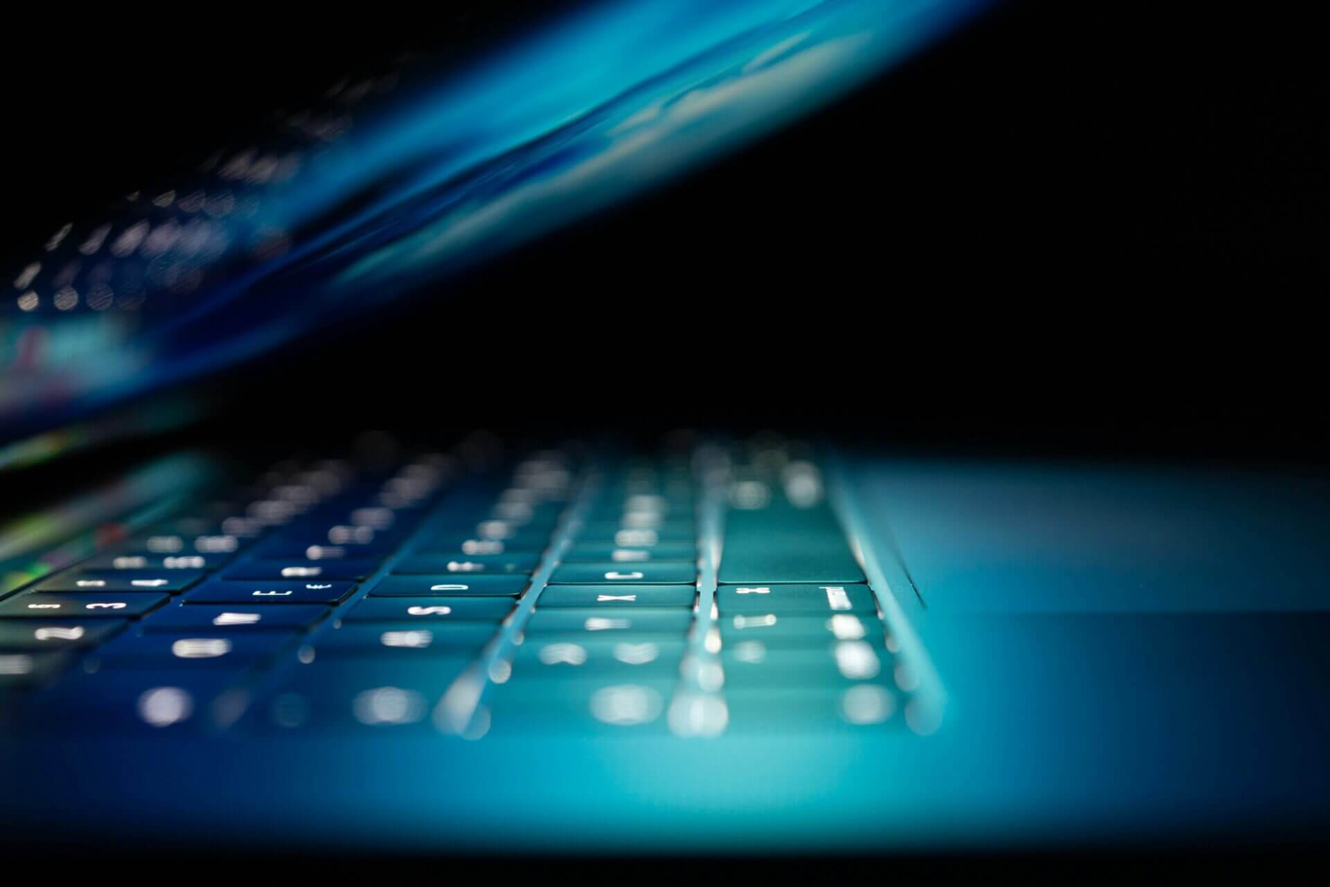 laptop keyboard in a dimly lit room